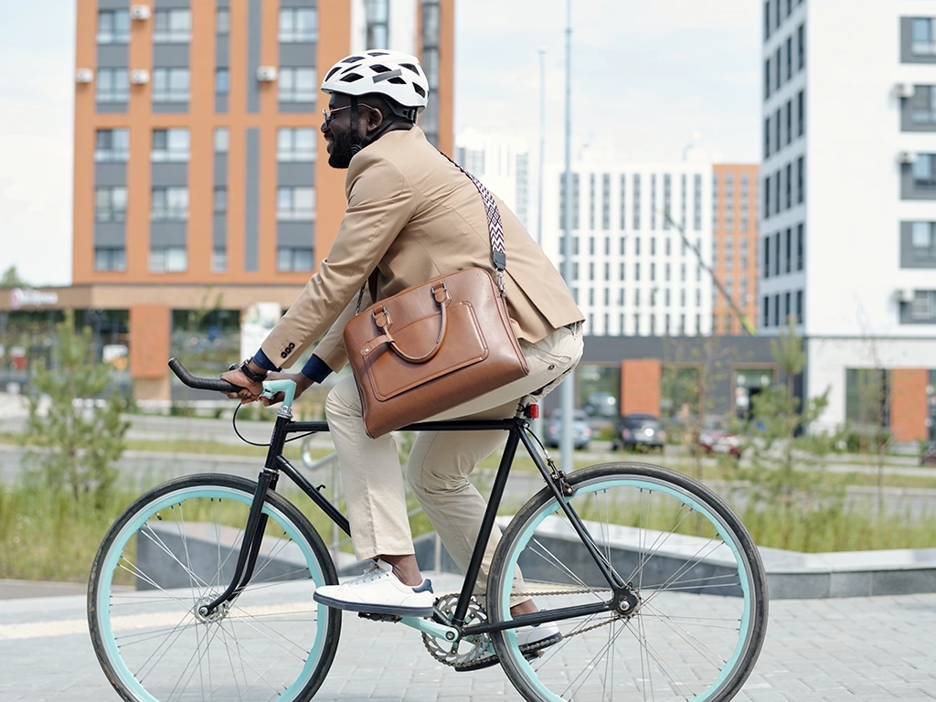 man biking to work with briefcase